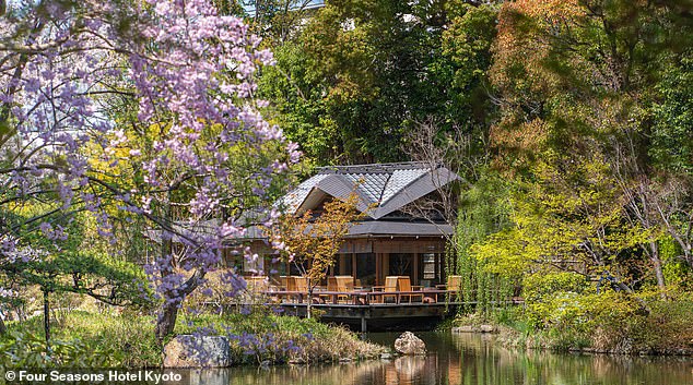 The cypress wood tea house overlooking the tranquil garden pond.