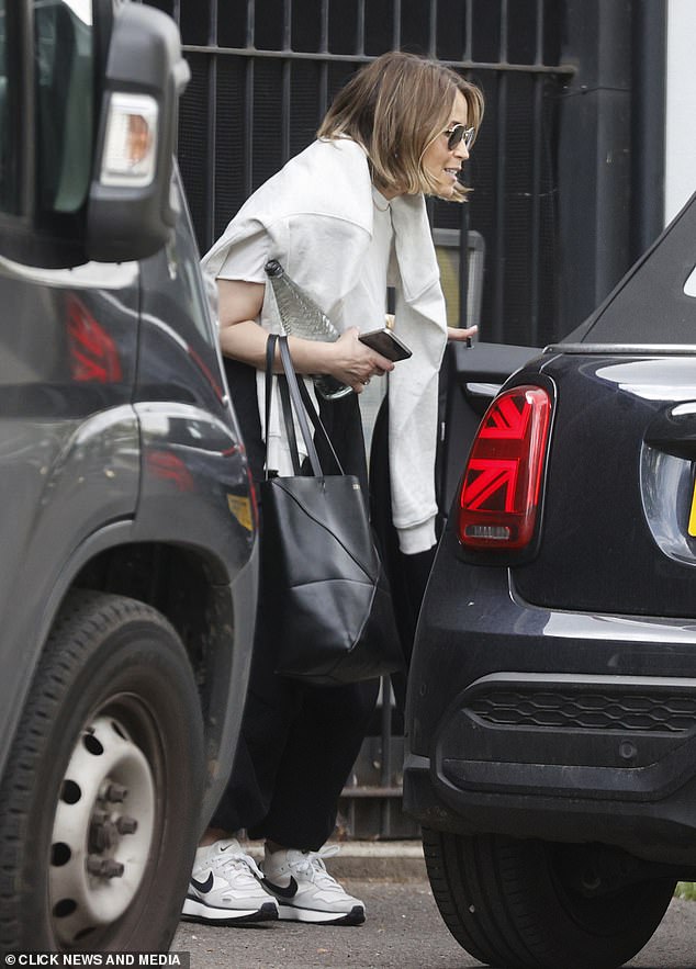 Rachel opted for a casual look for the shoot as she stepped out in a pair of black joggers, a white T-shirt and a gray jumper draped over her shoulders.