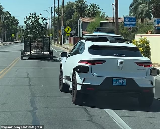 The video shows the Jaguar I-PACE crossing an intersection before turning onto the highway's cycle lane.