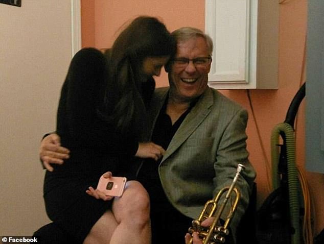 Vann, a retired teacher turned musician, holds a saxophone while Courtney sits on his lap. The two met through her shared love of music, when he was helping her find musicians for an event.