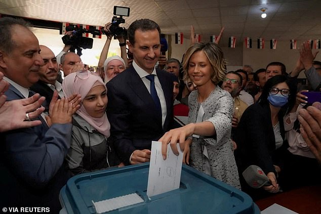 Asma al-Assad, wife of Syrian President Bashar al-Assad, votes during the country's presidential election in Douma, Syria, with her husband in this file photo taken in 2021.