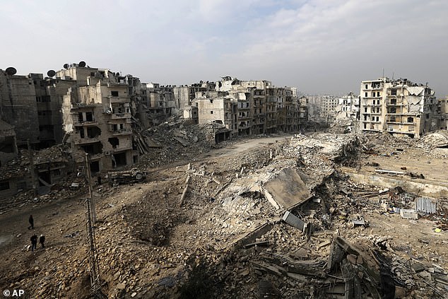 The Syrian civil war, which has killed nearly half a million people and displaced half of the country's pre-war population of 23 million, began as peaceful protests against Assad's government in March 2011. The protests were responded with brutal repression and the revolt quickly escalated into a full-blown civil war. Pictured: An Aleppo neighborhood reduced to rubble in 2017 (file photo)