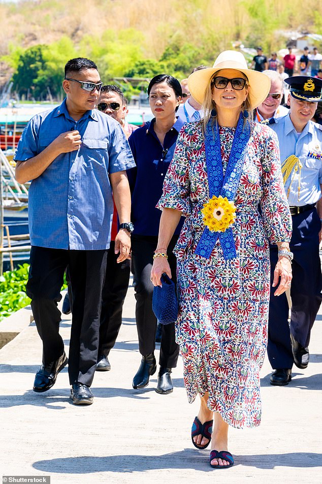 They gave her a decorative garland with a yellow flower, which perfectly complemented her floral ensemble.