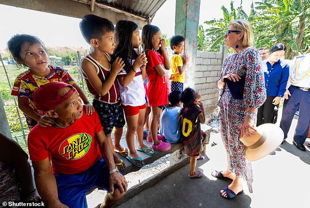 The Queen of Holland greeted a group of children. It seemed like the royal had said something that made them laugh.