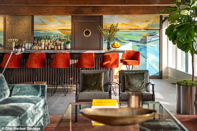 At the hotel there is a rectangular, marble-topped bar with bright orange stools, a selection of hard liquor, and additional seating space nearby. The cocktail menu will include drinks inspired by the area and the property's history.