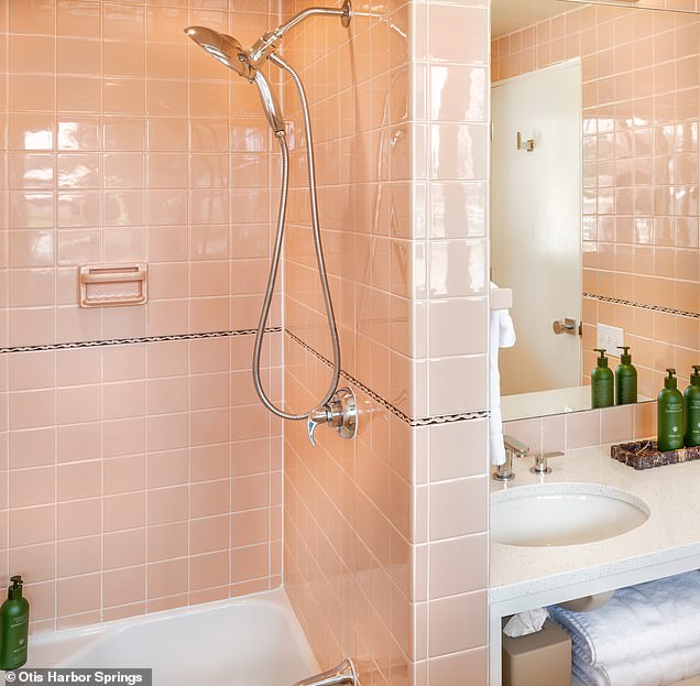 The updated bathroom at the Otis Harbor Springs hotel covered in salmon-colored tile