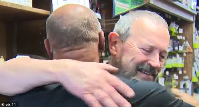 Vultee is seen hugging longtime client and friend Brian White on Friday as he became emotional about the news.