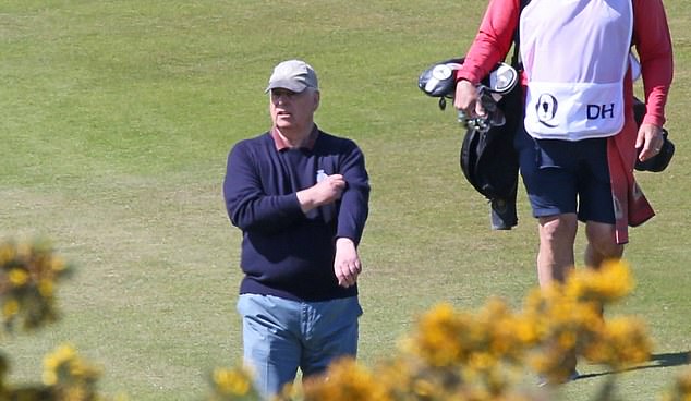 The Duke of York pictured rolling up his sleeves as the sun hits the golf course today