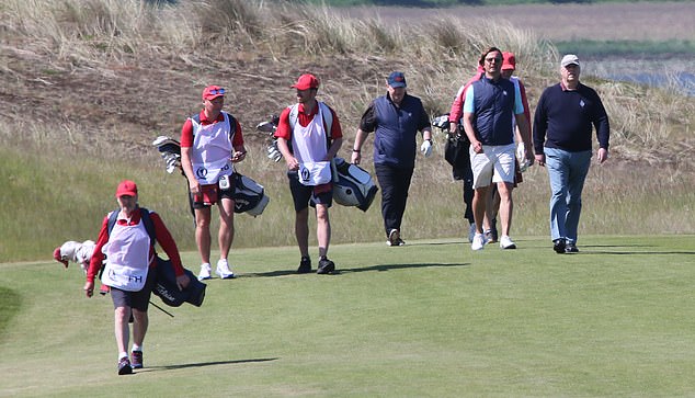 Prince Andrew pictured walking towards his next shot on the Scottish golf course this morning