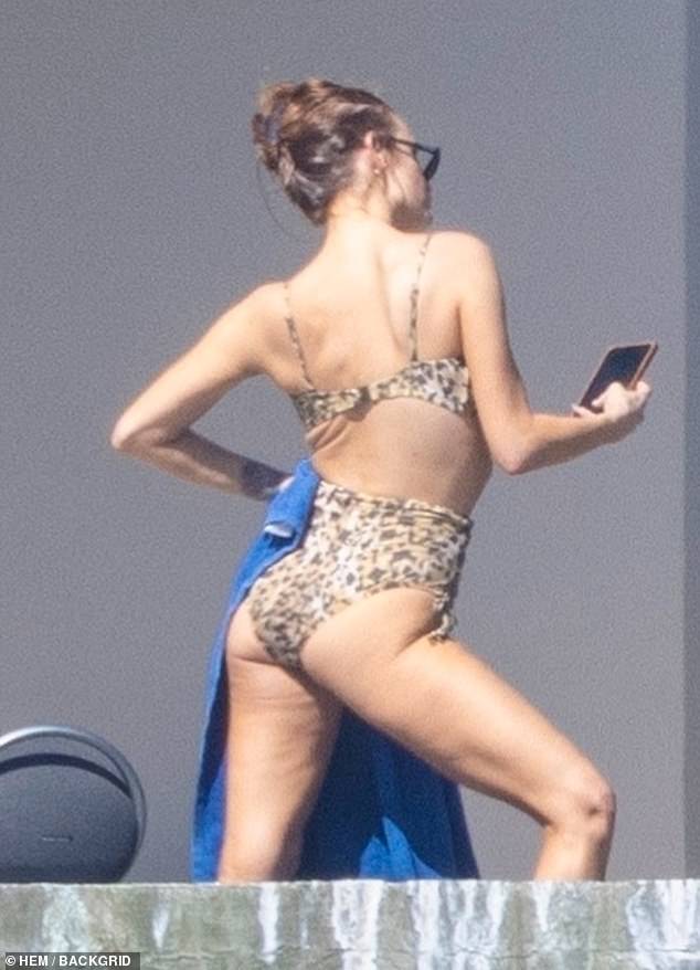 The 39-year-old singer-turned-socialite struck a wild pose while taking selfies in a leopard-print swimsuit.