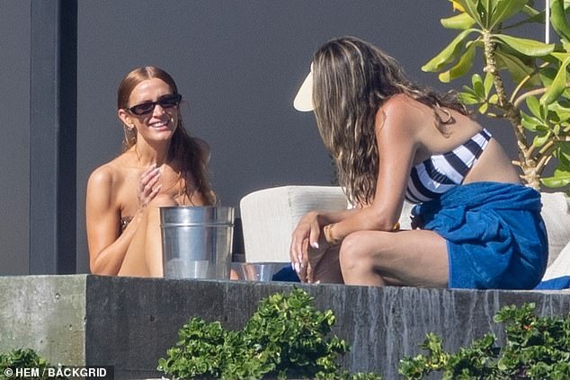 Simpson, who has a paid partnership with Nobu Hotel Los Cabos, took a dip in the seaside hot tub alongside a friend wearing a retro visor and a black-and-white striped bikini top.