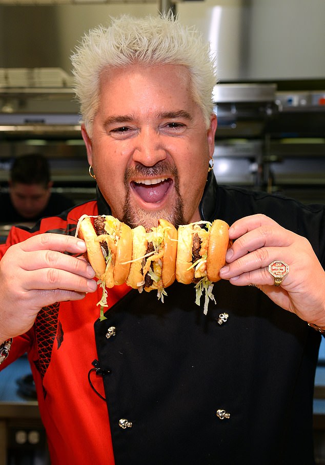 Fieri photographed with a stack of sandwiches at his restaurant in Las Vegas in April 2014.