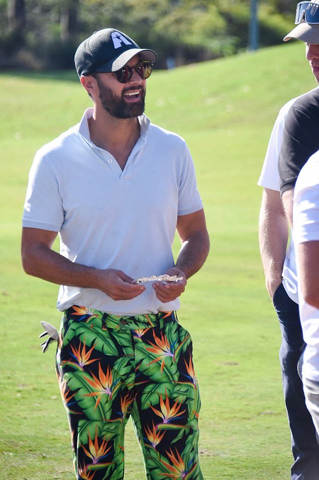 Cameron looked dapper in a white polo shirt and floral pants as he put on a very daring display.