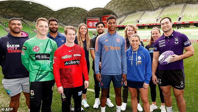 Manchester United star Rashford (pictured middle) also posed with members of several Melbourne sports clubs while in Australia.