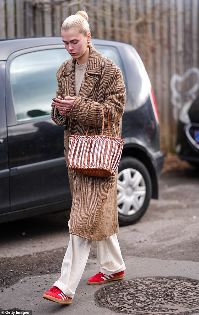 A guest at Copenhagen Fashion Week in January 2024 was spotted wearing a pair of bright red Adidas Gazelles.