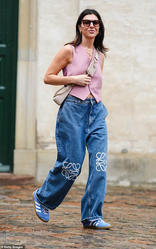 Influencer Francesca Saffari seen wearing blue Adidas Gazelles with Loewe jeans at Copenhagen Fashion Week in August 2023