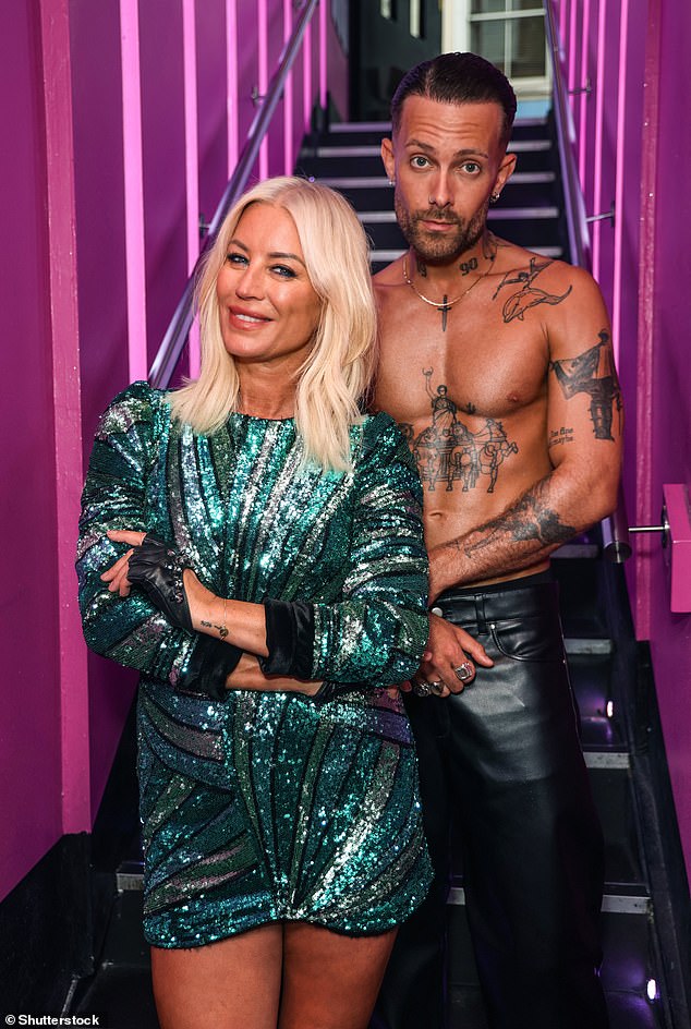 Denise smiled as she posed with the shirtless dancer.