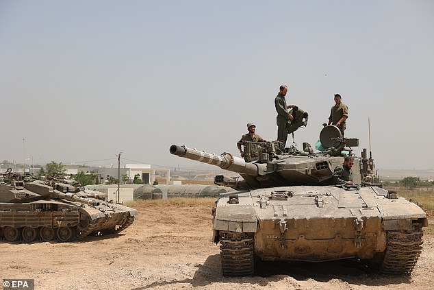 Israeli soldiers with their tanks gather at an undisclosed location near the border fence with the Gaza Strip, southern Israel, on May 21, 2024.