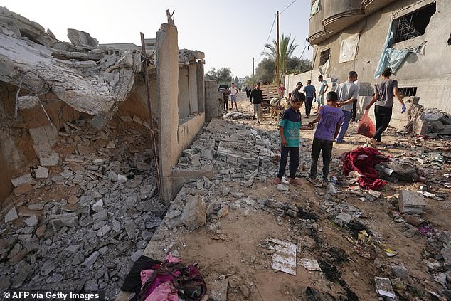 Palestinians inspect damage following Israeli attacks early on May 22, 2024.