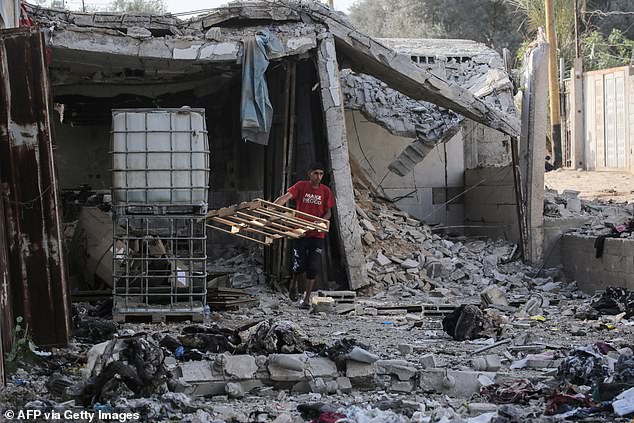 A young Palestinian inspects the damage following the Israeli bombing early on May 22, 2024.