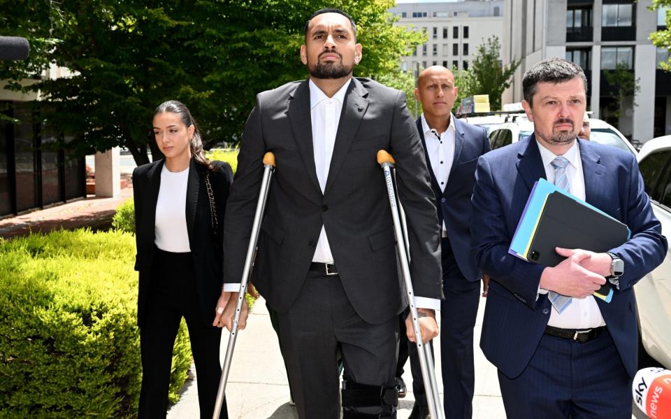 Nick Kyrgios appears in Canberra Magistrates Court on crutches