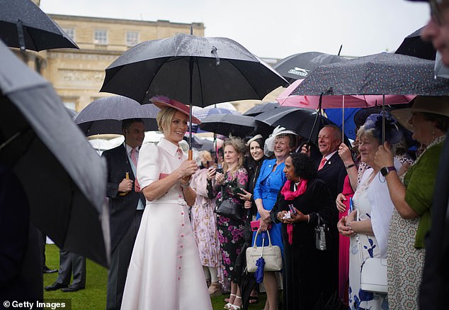 Despite the bad weather, the party continued with guests protected under umbrellas.