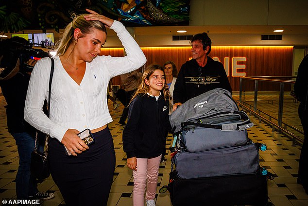 Australian tourists Monique (left), Juliett (center) and Pascal Urban (right) arrive from New Caledonia.