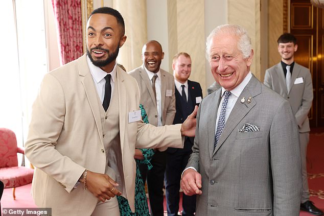 Tyler West and King Charles III fist bump during a reception for the winners of the 20th Prince's Trust Awards.