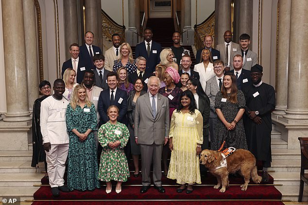 Charles, centre, poses with ambassadors and winners of the Prince's Trust Awards, during a reception for the winners of the 20th Prince's Trust Awards at Buckingham Palace.