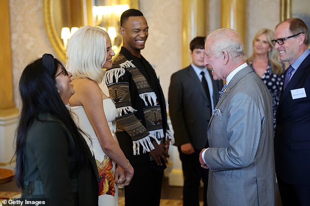 The King is seen chatting with Pixie Lott, one of the various celebrity guests in attendance.