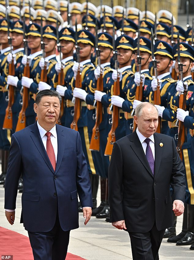 Chinese President Xi Jinping, left, and Russian President Vladimir Putin review the honor guard during an official welcoming ceremony in Beijing, China, Thursday, May 16, 2024.