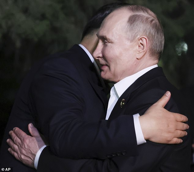 Chinese President Xi Jinping, left, and Russian President Vladimir Putin hug after an informal meeting in Beijing, China, Thursday, May 16, 2024.