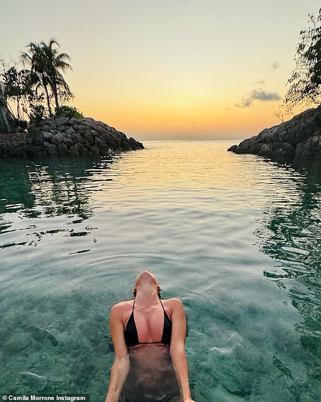 Here's a closer look at Camila's busty photo as the sun sets in the background.