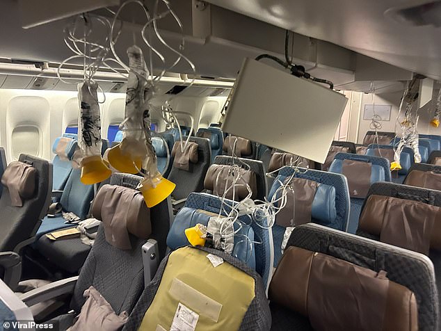 Oxygen masks seen hanging from ceiling in Singapore Airlines flight cabin