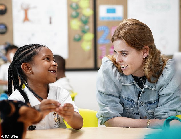 Beatrice seemed in high spirits as she sat with the students and chatted with them in their classrooms.