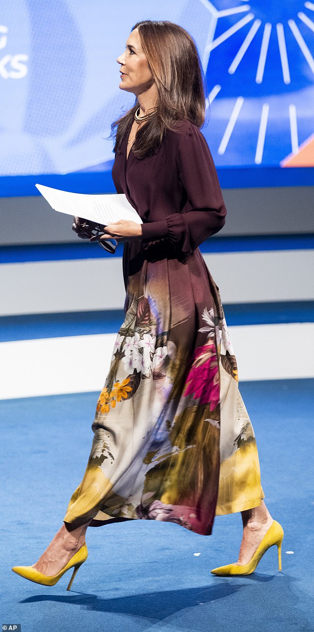 The royal mother cut an elegant figure in a long printed silk skirt and a plum-colored long-sleeved blouse.