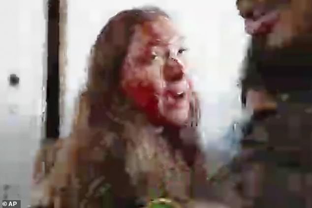 This image taken from a video provided by the Hostage Families Forum shows a bloodied female Israeli soldier from the Nahal Oz military base after she was taken captive by Hamas on October 7.