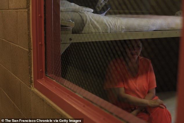 An inmate sits in her cell at the Central California Women's Facility, which now also houses dozens of male-to-female trans detainees.