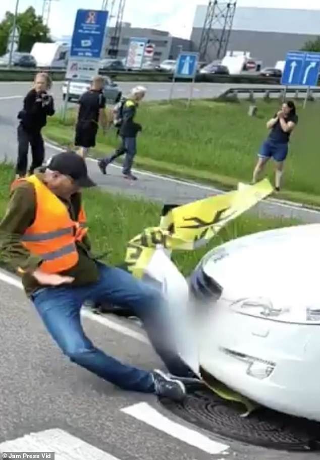 In a shocking video, a male eco-protester is seen being knocked to the ground by a moving vehicle.