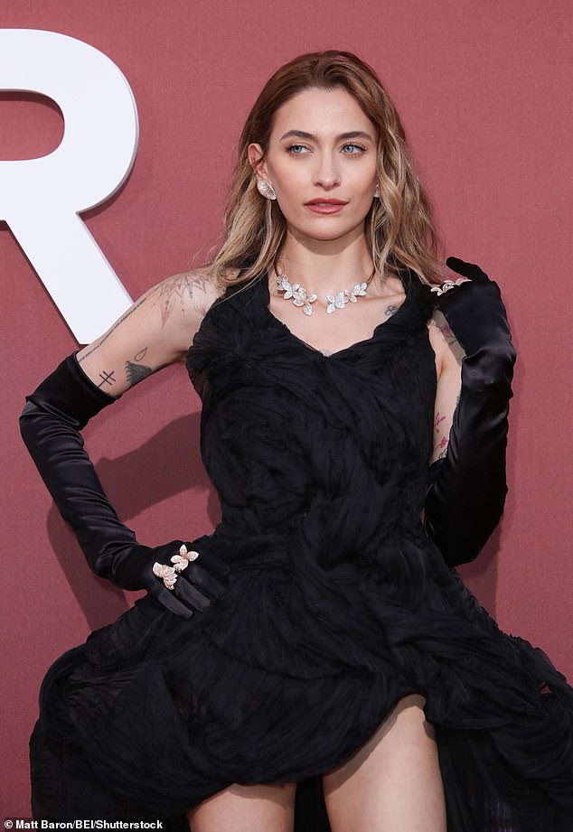 She elevated the elegance of her ensemble with a pair of satin evening gloves and a slew of floral diamond jewelry, including a choker, earrings, and several rings.