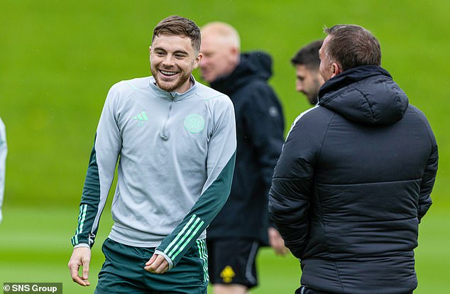 Rodgers speaks briefly to James Forrest, who has been called up to the Scotland squad