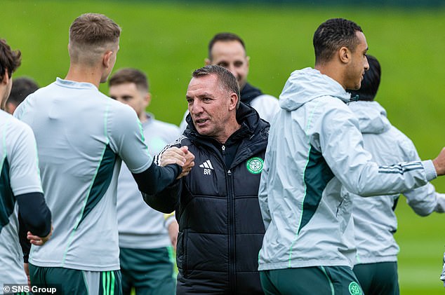 The Celtic manager appears relaxed while chatting with his players in training