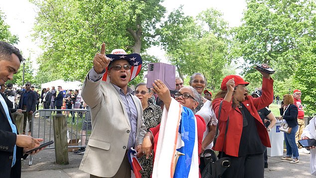 A Latino group dances to the popular Spanish jingle of the Trump campaign