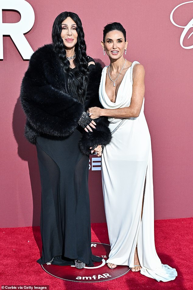 Earlier on the red carpet, Demi and Cher posed together in contrasting dresses, with Demi wearing white and Cher opting for a black suit.