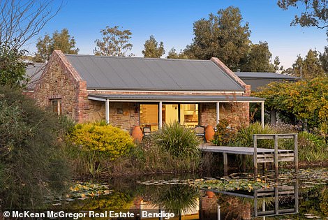 Inside there is a small studio with an open plan kitchen, living and dining room that opens onto a covered terrace that connects to the small jetty over the pond.