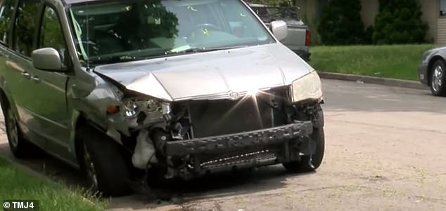 A gray sedan crashed into a parked minivan and caused significant damage, with debris flying everywhere.