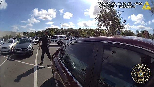 While waiting for firefighters, an officer decided to break the window on his own since the baby was trapped in the hot car.