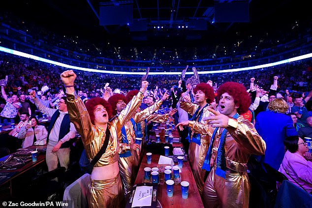 Costumed fans watch the final between Littler and Humphries on Thursday night.