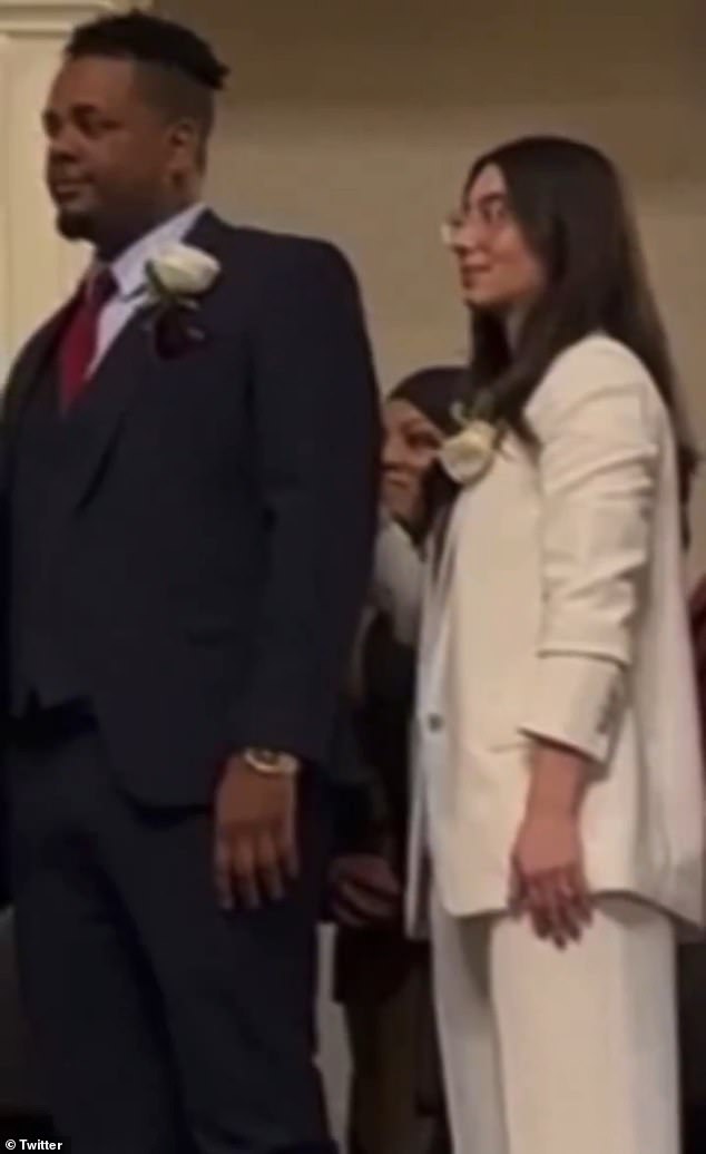 Tania Fernandes Anderson (pictured in the middle background) appeared not to repeat the oath in a video that has since gone viral on social media after the ceremony at City Hall.