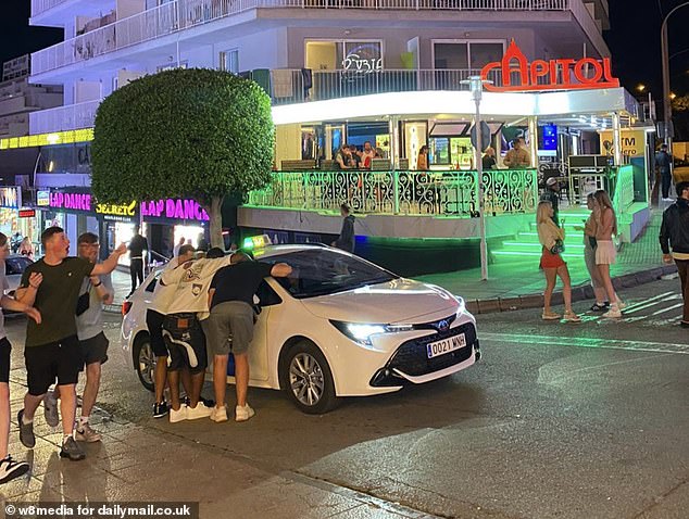 British tourists could face holiday chaos this summer as Mallorcans step up their anti-tourism campaign by threatening to blockade the island's airport and protest outside hotels (pictured: tourists partying in Mallorca).